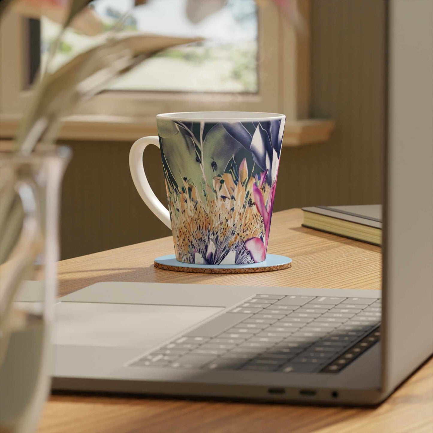 Bright Floral patterned ceramic Latte Mug with c shaped handle 12oz - scratch resistant 'Africa Blooms' Latte Mug, 12oz - Free Shipping in Canada. Picture beside an open laptop on a desk
