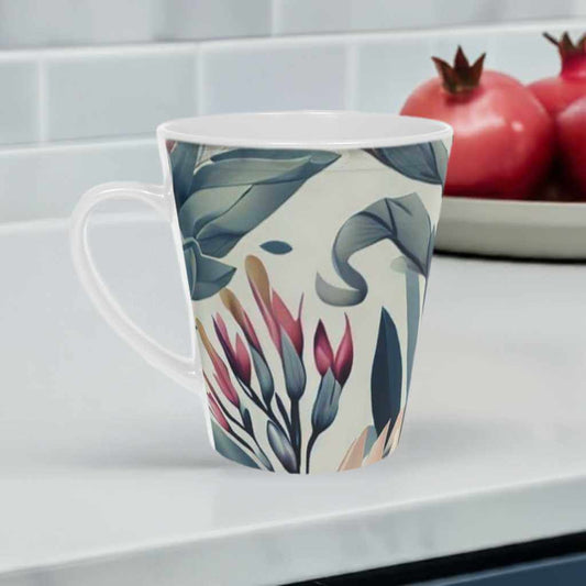 'Bohemian Garden' Latte Mug, 12oz scratch resistant white ceramic. Sage green and burgundy botanical print. Perfect cup for enjoying your favorite drink in style. pictured on a white kitchen counter.  white subway style backsplash ad a bowl of pomegranates
